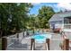 Beautiful backyard pool surrounded by lush greenery and ample seating at 2610 Ginger Dr, Buford, GA 30519