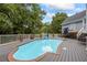 A swimming pool with a gray deck and patio furniture, surrounded by white fencing at 2610 Ginger Dr, Buford, GA 30519