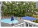 A private pool area featuring a spacious gray deck and shaded by mature trees at 2610 Ginger Dr, Buford, GA 30519
