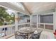Relaxing screened porch with tile floors, outdoor dining, and backyard view at 2610 Ginger Dr, Buford, GA 30519