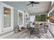 Relaxing screened porch with tile floors, outdoor dining, and a ceiling fan at 2610 Ginger Dr, Buford, GA 30519