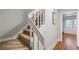 Staircase with carpeted stairs leading up, and an entryway leading to a room at 2610 Ginger Dr, Buford, GA 30519