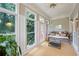 Sunroom features many windows, neutral decor, and a comfortable couch at 2610 Ginger Dr, Buford, GA 30519