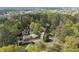 Aerial view of homes surrounded by lush trees, with the city skyline in the background at 2811 Shady Valley Ne Dr, Brookhaven, GA 30324