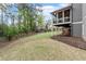 Expansive backyard featuring a screened-in porch, lush greenery, and a wooded perimeter for privacy at 2811 Shady Valley Ne Dr, Brookhaven, GA 30324