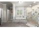 Luxurious bathroom features a soaking tub, a glass enclosed shower, and marble tile at 2811 Shady Valley Ne Dr, Brookhaven, GA 30324
