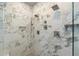Elegant marble tiled shower features multiple shower heads and built-in niches at 2811 Shady Valley Ne Dr, Brookhaven, GA 30324