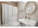 A classic bathroom with a white pedestal sink, oval mirror and bathtub with shower at 2811 Shady Valley Ne Dr, Brookhaven, GA 30324