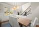 Dining room showcasing modern light fixture, tall windows, and stairway at 2811 Shady Valley Ne Dr, Brookhaven, GA 30324