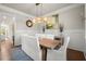 Light filled dining room featuring a modern light fixture and wall paneling at 2811 Shady Valley Ne Dr, Brookhaven, GA 30324