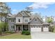Charming two-story home with stone accents, three-car garage, well-manicured lawn, and lush landscaping at 2811 Shady Valley Ne Dr, Brookhaven, GA 30324