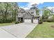 Charming home featuring a long driveway, a three-car garage, and beautiful landscaping at 2811 Shady Valley Ne Dr, Brookhaven, GA 30324