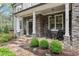 Inviting front porch featuring stone accents, rocking chairs, and professional landscaping at 2811 Shady Valley Ne Dr, Brookhaven, GA 30324