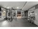 Home gym with weight rack, bench, dumbbells, mirror and view to media room at 2811 Shady Valley Ne Dr, Brookhaven, GA 30324