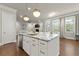 Kitchen island features a sink, dishwasher, seating and flows into the living area with abundant natural light at 2811 Shady Valley Ne Dr, Brookhaven, GA 30324