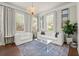 Cozy sitting area featuring natural light, modern furniture and an ornate crystal chandelier at 2811 Shady Valley Ne Dr, Brookhaven, GA 30324