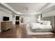 Large main bedroom featuring tray ceilings, hardwood floors, and an ensuite bathroom at 2811 Shady Valley Ne Dr, Brookhaven, GA 30324
