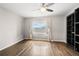 Bright room with hardwood floors features ceiling fan, built-in shelving and natural light at 3435 Kingsboro Ne Rd # 603, Atlanta, GA 30326