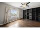 Bedroom features hardwood flooring, ceiling fan, large windows and a full wall of built in shelving at 3435 Kingsboro Ne Rd # 603, Atlanta, GA 30326