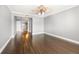 Open bedroom with wood floors, fan, and views to the kitchen and hall at 3435 Kingsboro Ne Rd # 603, Atlanta, GA 30326