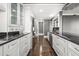 Modern kitchen features sleek white cabinetry, stainless steel appliances, and black marble countertops at 3435 Kingsboro Ne Rd # 603, Atlanta, GA 30326