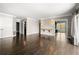 Open-concept living room featuring hardwood floors, sconces, and natural light at 3435 Kingsboro Ne Rd # 603, Atlanta, GA 30326