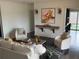 Bright living room with white sofa, two chairs, and a decorative rug on dark hardwood floors at 3435 Kingsboro Ne Rd # 603, Atlanta, GA 30326