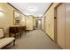Hallway featuring neutral colors, an elevator, carpet, and decorative furniture at 3435 Kingsboro Ne Rd # 603, Atlanta, GA 30326