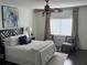 Cozy main bedroom featuring a ceiling fan, decorative rug, and two chairs next to a window at 3435 Kingsboro Ne Rd # 603, Atlanta, GA 30326