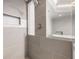 Modern shower detail with neutral tile, decorative inlay and convenient shelf at 3435 Kingsboro Ne Rd # 603, Atlanta, GA 30326