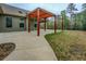 Inviting backyard with a custom wooden pergola on concrete patio at 9117 Dearing St, Covington, GA 30014