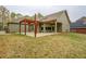 Large backyard with a covered patio and wooden pergola at 9117 Dearing St, Covington, GA 30014