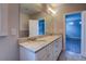 Bathroom featuring a double sink vanity with granite countertops and modern fixtures at 9117 Dearing St, Covington, GA 30014