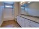 Bathroom with granite countertops, ample cabinet space, and a bathtub at 9117 Dearing St, Covington, GA 30014
