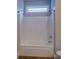 Clean bathtub with shower head and window at 9117 Dearing St, Covington, GA 30014