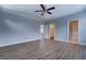 Spacious bedroom with hardwood floors, ceiling fan, and ensuite bathroom and closet at 9117 Dearing St, Covington, GA 30014