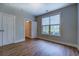 Bright bedroom features wood-look floors, window, and ample closet space at 9117 Dearing St, Covington, GA 30014