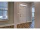 Welcoming entryway featuring wood-look flooring, white trim, and natural light from sidelight windows at 9117 Dearing St, Covington, GA 30014