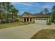 Charming home with lush landscaping, a two-car garage and long driveway at 9117 Dearing St, Covington, GA 30014