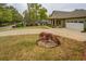 Well-maintained front yard with mature trees, landscaped features, and a long drive at 9117 Dearing St, Covington, GA 30014