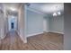 Bright hallway with wood-look flooring leading to an open-concept dining area at 9117 Dearing St, Covington, GA 30014