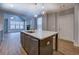 Open kitchen showcasing an island with a sink and a view into a living area at 9117 Dearing St, Covington, GA 30014