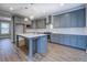 Stylish kitchen with gray cabinetry, modern appliances, and a functional center island at 9117 Dearing St, Covington, GA 30014