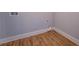 Empty laundry room with hardwood floors, washer hookups, and fresh paint at 9117 Dearing St, Covington, GA 30014