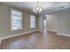 Sunlit room with wood-look floors, neutral paint, and views to an adjacent room at 9117 Dearing St, Covington, GA 30014
