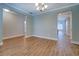 Open living room with wood-look floors and neutral colors and connecting hallways at 9117 Dearing St, Covington, GA 30014