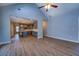 Open floor plan with hardwood floors connecting living room to modern kitchen with stainless appliances at 9117 Dearing St, Covington, GA 30014