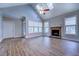 Living room featuring vaulted ceiling, skylights, a ceiling fan, a brick fireplace, and large windows at 9117 Dearing St, Covington, GA 30014
