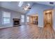 Open-concept living room featuring a brick fireplace, lots of windows, and access to the kitchen at 9117 Dearing St, Covington, GA 30014