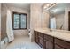 Bathroom with white tile flooring, vanity, sink, a tub with shower, and floral wallpaper at 103 Nob Hl, Peachtree City, GA 30269